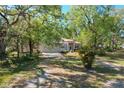 Inviting single Gathering home surrounded by mature trees and lush landscaping, offering great curb appeal at 2920 Ewell Rd, Lakeland, FL 33811