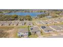 Stunning aerial view showcasing the neighborhood homes near a beautiful lake at 928 Cambridge Dr, Winter Haven, FL 33881