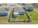 Aerial view of a cozy fenced backyard with a screened in porch and green lawn at 928 Cambridge Dr, Winter Haven, FL 33881