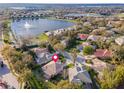 Aerial view of a home in a lakeside community with mature trees and meticulously maintained lawns at 1229 Sebastian Cv, Lake Mary, FL 32746