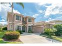 Beautiful home with a well-manicured lawn, lush landscaping, and a grand entryway at 1229 Sebastian Cv, Lake Mary, FL 32746