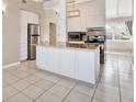 Modern kitchen with stainless steel appliances and a center island with granite countertops at 2421 Cypress Ln, Lakeland, FL 33801