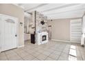 Bright living room featuring a decorative fireplace, open layout, and tiled flooring at 2421 Cypress Ln, Lakeland, FL 33801