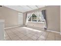 Sunlit room with large window, tile flooring, and neutral color palette at 2421 Cypress Ln, Lakeland, FL 33801