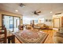 Comfortable living room featuring wood floors, a ceiling fan, and a view into the dining area at 9415 Cat Track Trl, Lake Wales, FL 33898