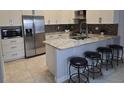 Modern kitchen featuring stainless steel appliances, granite countertops and breakfast bar at 2691 Cedaridge Cir, Clermont, FL 34711