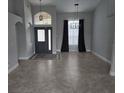 Open living area featuring tile floors, a stylish pendant light, and large windows at 2691 Cedaridge Cir, Clermont, FL 34711