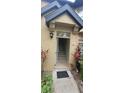 Inviting front entrance showcasing exterior lighting, neutral paint, and a clear path leading into the home at 6372 Raleigh St # 1911, Orlando, FL 32835