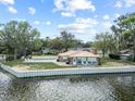 Tranquil waterfront home featuring a pool and a patio sitting area at 830 County Rd 457, Lake Panasoffkee, FL 33538