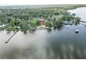 Waterfront property featuring a home with a pool and its own private access to the water at 830 County Rd 457, Lake Panasoffkee, FL 33538