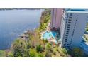Poolside view highlighting lush landscaping and serene waterfront location of condo complex at 13415 Blue Heron Beach Dr # 1201, Orlando, FL 32821