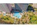 Overhead shot of a large outdoor swimming pool, surrounded by lush greenery and lounge chairs at 13415 Blue Heron Beach Dr # 1201, Orlando, FL 32821