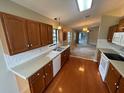 Bright kitchen with wooden cabinets, white appliances, and laminate countertops at 669 Eagle Run, Lakeland, FL 33809