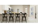 A stylish kitchen features a breakfast bar with seating and stainless steel appliances at 2264 Red Sun Way, Apopka, FL 32703
