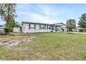 Single-story home featuring a spacious lawn and a convenient carport at 122 2Nd Jpv St, Winter Haven, FL 33880