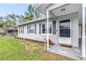 Close-up of a home's entrance featuring a well-kept lawn and charming shutters at 122 2Nd Jpv St, Winter Haven, FL 33880