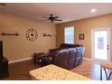 Comfortable living room featuring a plush leather sofa and hardwood flooring at 15387 Avenue Of The Arbors, Winter Garden, FL 34787