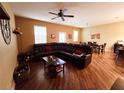 Spacious living room features stylish wood floors, modern fan, and comfortable seating at 15387 Avenue Of The Arbors, Winter Garden, FL 34787