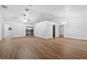 Spacious living room with vaulted ceilings and wood-look vinyl flooring throughout at 25 Inconnu Dr, Kissimmee, FL 34759