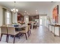 Spacious dining area open to the kitchen features stylish chandelier, and lots of natural light at 4117 Jespersen St, Apopka, FL 32712