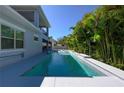 Inviting in-ground pool surrounded by lush greenery, perfect for relaxation and recreation at 108 Stanton Estates Cir, Winter Garden, FL 34787