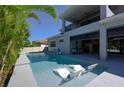 Inviting in-ground pool with in-water loungers and an covered outdoor space, perfect for relaxation and entertainment at 108 Stanton Estates Cir, Winter Garden, FL 34787