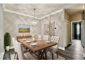 Elegant dining room featuring a dining table with seating for six, modern lighting, and artwork at 130 Southern Pecan Cir # 205, Winter Garden, FL 34787