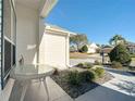 Exterior view with a table and chairs, showcasing the home's setting with landscaped surroundings at 2518 Foxbridge Ter, The Villages, FL 32162