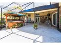 Expansive covered patio featuring a hot tub, seating area, and ample space for outdoor entertaining at 105 Country Club Ln, Mulberry, FL 33860
