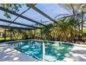 Inviting screened-in pool with clear blue water, surrounded by a concrete deck and lush greenery at 105 Country Club Ln, Mulberry, FL 33860