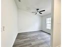 Bright, minimalist bedroom with a ceiling fan and wood-look flooring at 1390 Patricia St, Kissimmee, FL 34744