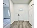 Inviting foyer showcasing wood-look flooring and a bright white front door at 1390 Patricia St, Kissimmee, FL 34744