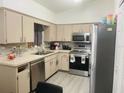 Functional kitchen with stainless steel appliances, tile backsplash, and ample counter space at 250 Ashley Rd, Mascotte, FL 34753