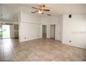 Bright living room with tile floors, ceiling fan, and neutral paint, creating a welcoming atmosphere at 250 Ashley Rd, Mascotte, FL 34753
