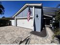 Wide driveway leading to a 2-car garage with a beautiful blue exterior and an American flag at 105 Ingram Cir, Longwood, FL 32779