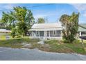Charming single Gathering home featuring a welcoming front porch and mature trees at 215 Maple Ln, Fort Meade, FL 33841