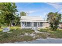 Charming single Gathering home featuring a welcoming front porch and mature trees at 215 Maple Ln, Fort Meade, FL 33841