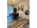 Cozy dining area with modern lighting and a sliding glass door for natural light at 228 Babson Dr, Babson Park, FL 33827