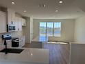 Bright and airy kitchen with quartz countertops, island, and view of the lake at 15088 Grove Lake Dr, Winter Garden, FL 34787
