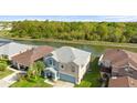 Aerial view of a two-story home with a gray roof and a pond in the backyard at 3189 Kearns Rd, Mulberry, FL 33860