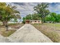 View of home and driveway showing the property's curb appeal and access at 824 Interlake Dr, Lakeland, FL 33801