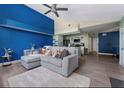 Bright living room with a blue accent wall, modern furniture, and stylish decor, creating a cozy and inviting space at 5012 Laguna Bay Cir # 72, Kissimmee, FL 34746