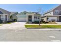 Inviting single-Gathering home with a two-car garage, landscaped yard, and covered front entrance at 6221 Trailblaze Bnd, St Cloud, FL 34771
