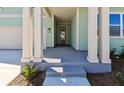 Welcoming front porch with decorative pillars and a modern front door, perfect for relaxing at 6221 Trailblaze Bnd, St Cloud, FL 34771