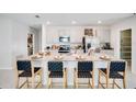 A modern kitchen with stainless steel appliances and a large center island with seating at 7396 Capstone Dr, Groveland, FL 34736