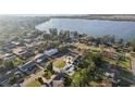 Aerial view of a single story home featuring a well manicured lawn and mature trees at 1841 5Th Se St, Winter Haven, FL 33880