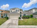 Beautiful two-story home featuring a well-manicured lawn, mature landscaping, and a convenient two-car garage at 14110 Sapphire Bay Cir, Orlando, FL 32828