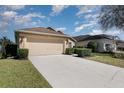 Well-kept home featuring a two-car garage, tidy front lawn, and convenient driveway at 540 Buckingham Cir, Davenport, FL 33897