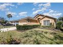 Inviting single-story home with well-maintained landscaping, a two-car garage, and a cozy front yard at 540 Buckingham Cir, Davenport, FL 33897