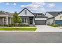 Charming home with gray trim, stone accents, a well-manicured lawn, and an attached two-car garage at 6615 Quest St, St Cloud, FL 34771